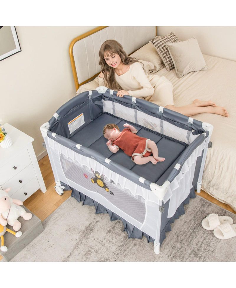 Baby 4-in-1 Convertible Baby Bassinet with Changing Table, Music Box and Wheels